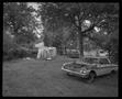 Photograph: [Car with no hood in a backyard]