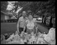 Photograph: [Elderly people behind a table full of dolls]