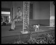 Photograph: [Man on a porch with a dog]