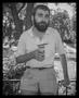 Photograph: [Man holding a glass and cigarette]