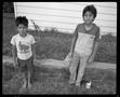 Photograph: [Two small children in their yard]