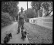 Photograph: [Man with two small dogs]
