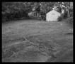 Photograph: [Yard with Garage and Pile of Sticks, 1987]