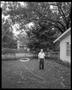 Photograph: [Dad in Yard with Hose, 2002]