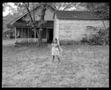 Photograph: [Little Girl Behind House 1976]