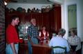 Photograph: [Five individuals conversing in a kitchen at the Country Place]