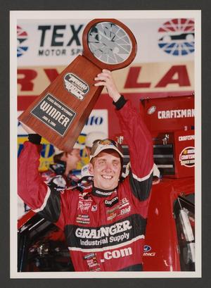 Primary view of object titled '[Greg Biffle posing with a trophy]'.