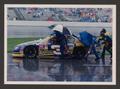 Photograph: [Crew members pushing Ron Hornaday's car down pit road amidst rain]