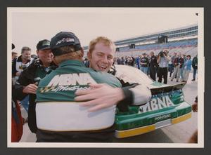 Primary view of object titled '[Jason Leffler hugging a member of his crew]'.