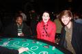 Photograph: [Three UNT Students Smile at Poker Table]
