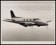 Photograph: [A small airplane in flight]