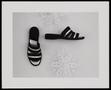 Photograph: [A pair of slip-on shoes and decorative objects]