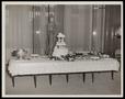 Photograph: [A wedding cake in front of a statue]