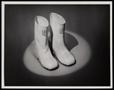 Photograph: [A pair of rain boots under a spotlight]