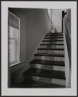 Primary view of object titled '[Man seated on staircase landing]'.