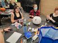 Primary view of [Group decorating their scary pumpkin]