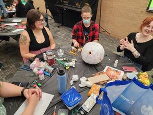 Primary view of object titled '[Group decorating their scary pumpkin, 2]'.