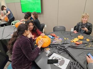 Primary view of object titled '[Students carving on spare pumpkin]'.