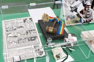 Primary view of object titled '[Display case with LGBTQ+ memorabilia]'.