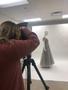 Primary view of [Megan Detoso photographing an evening dress, 2]