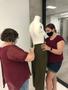 Photograph: [Janelle McCabe and Piper Head installing historic dress artifacts]