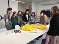 Photograph: [Students examine a suit designed by Michael Faircloth]