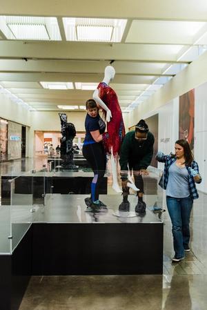 Primary view of object titled '[Annette Becker lifting a mannequin]'.
