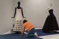 Photograph: [Janelle McCabe and Annette Becker placing a wedding dress on mannequ…