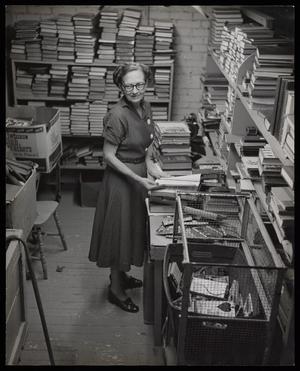 Primary view of object titled '[Goodwill Industries - Woman Sorting Books]'.