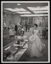 Photograph: [Neiman-Marcus store interior with a woman in a gown, 1]