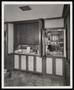 Photograph: [Open doors revealing cabinets and dishes]