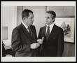 Photograph: [Two men in suits, one holding a wrench, 2]