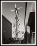 Photograph: [A windmill towering above a group of people]