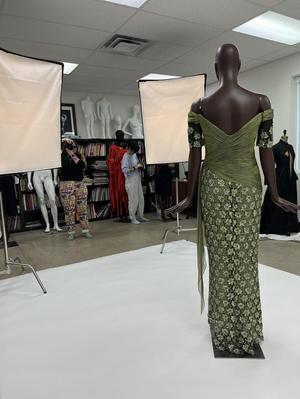 Primary view of object titled '[Anna Smith photographing a green evening dress]'.