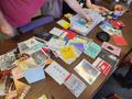 Primary view of [Table full of zines from Triangle Nonprofit Publishing Inc.]