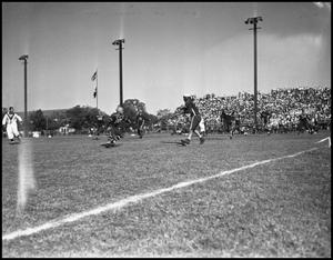Primary view of object titled '[A Play During a Football Game of Player Running, 1942]'.