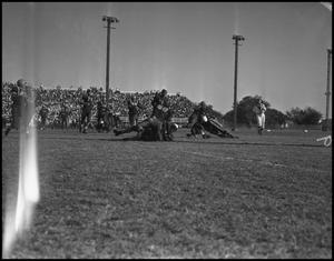 Primary view of object titled '[Football Players Tackling Each Other During a Play, 1942]'.
