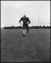 Photograph: [North Texas State University Jersey No. 74 Football Player Running, …