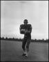 Photograph: Football Player No. 18 Clutching a Football, September 1962]