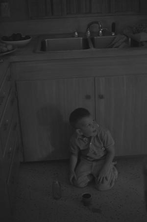 Primary view of object titled '[A boy on the floor with a cup, 2]'.