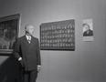 Photograph: [A man in front of a museum painting]