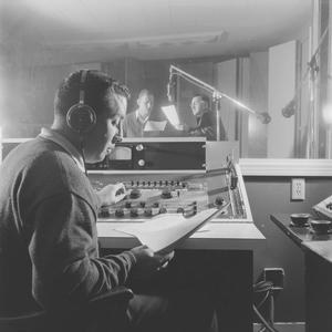 Primary view of object titled '[A man looking at paper in a recording room, 2]'.