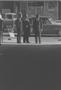 Photograph: [Three men talking on a street, 2]