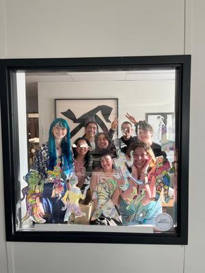 Primary view of object titled '[TFC staff with their creations attached to the glass window]'.