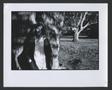 Primary view of [Young woman leaning against tree]