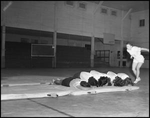 Primary view of object titled '[Women's gymnastics student tumbling, 1942]'.