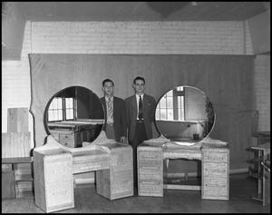 Primary view of object titled '[Two Men Standing With Handmade Vanity Desks]'.