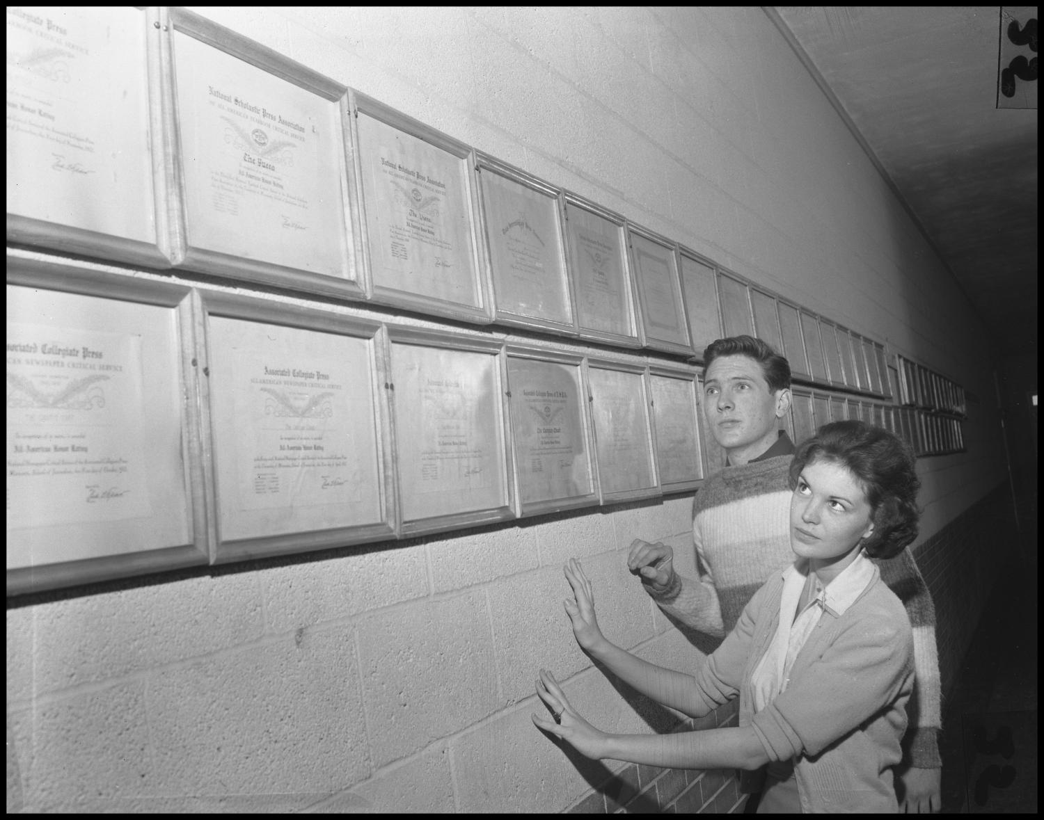 [Two students looking at wall of awards]
                                                
                                                    [Sequence #]: 1 of 1
                                                