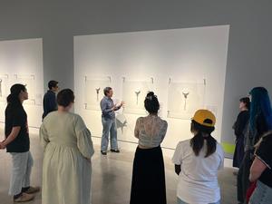 Primary view of object titled '[Professor Ana Lopez talking about a bolo tie on display, 2]'.