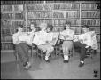 Photograph: [Students Reading Newspapers Together]